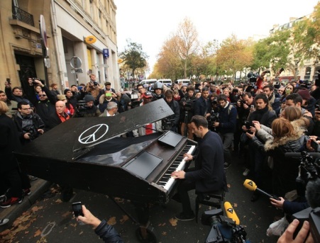 An unnamed man brings his portable grand piano and plays John Lennon's Imagine by the Bataclan, Paris, one of the venues for the attacks in the French capital which are feared to have killed around 120 people.